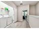 Hallway featuring laundry room, neutral walls, plush carpeting and view to a bedroom at 6745 Citrus Creek Ln, Tampa, FL 33625