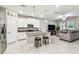 Modern kitchen with white cabinets, granite countertops, and stainless steel appliances at 6745 Citrus Creek Ln, Tampa, FL 33625