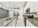 Open kitchen with white cabinets, granite counters, and stainless steel appliances at 6745 Citrus Creek Ln, Tampa, FL 33625