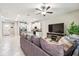 Inviting living room with open concept and kitchen, featuring a comfortable sofa, flat screen tv and modern lighting at 6745 Citrus Creek Ln, Tampa, FL 33625
