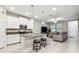 Open concept living space showcasing a modern kitchen and inviting seating area, with natural light from nearby windows at 6745 Citrus Creek Ln, Tampa, FL 33625