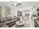 Charming living space with staircase, comfortable sofa, stylish coffee table, and an open layout to the modern kitchen at 6745 Citrus Creek Ln, Tampa, FL 33625
