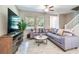 Comfortable living room features plush sectional sofa, decorative pillows, and a stylish coffee table with large windows at 6745 Citrus Creek Ln, Tampa, FL 33625