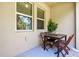 Cozy patio area with a table and chairs outside windows that are partially covered at 6745 Citrus Creek Ln, Tampa, FL 33625