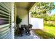 Covered patio area with a table and chairs and view of lush landscaping at 6745 Citrus Creek Ln, Tampa, FL 33625