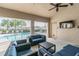 Relaxing outdoor lounge with comfortable seating, a TV, and a view of the community pool at 6745 Citrus Creek Ln, Tampa, FL 33625