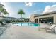Relaxing community pool with sun loungers, palm trees, and a covered lounge area at 6745 Citrus Creek Ln, Tampa, FL 33625
