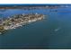Breathtaking aerial perspective of waterfront homes nestled along the coastline with boats on the bay at 7060 S Shore S Dr, South Pasadena, FL 33707