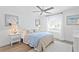 Serene bedroom features neutral decor, a ceiling fan, and a window with sheer curtains at 7060 S Shore S Dr, South Pasadena, FL 33707