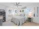 Cozy bedroom featuring white linens, bright window, and tasteful nautical decorations, creating a peaceful retreat at 7060 S Shore S Dr, South Pasadena, FL 33707