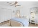 Inviting bedroom features a ceiling fan, closet, and neutral decor for a relaxing atmosphere at 7060 S Shore S Dr, South Pasadena, FL 33707