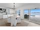 Light-filled dining area with water views and access to the patio and pool area through sliding glass doors at 7060 S Shore S Dr, South Pasadena, FL 33707