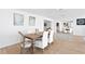 Charming dining room showcasing natural light, wood floors, and an inviting ambiance for delightful meals at 7060 S Shore S Dr, South Pasadena, FL 33707