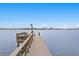 Picturesque waterfront dock featuring a wooden structure, a grill and a scenic view of the cityscape at 7060 S Shore S Dr, South Pasadena, FL 33707
