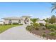 Inviting single-story home with elegant landscaping and a brick driveway that leads to a grand entrance at 7060 S Shore S Dr, South Pasadena, FL 33707
