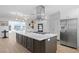 Bright kitchen with stainless steel appliances, white cabinetry and marble countertop island with built in stovetop at 7060 S Shore S Dr, South Pasadena, FL 33707