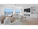 Bright living room with water view, fireplace, and custom built-ins offer a comfortable space for relaxation at 7060 S Shore S Dr, South Pasadena, FL 33707