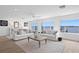 Serene living room featuring comfortable seating, waterfront view, and stylish decor for luxurious living at 7060 S Shore S Dr, South Pasadena, FL 33707