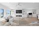 Bright living room features a sleek fireplace and custom built-ins providing storage and elegance at 7060 S Shore S Dr, South Pasadena, FL 33707