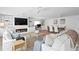 Open-concept living space with fireplace and dining area provides a seamless flow for modern living and entertaining at 7060 S Shore S Dr, South Pasadena, FL 33707