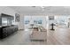 Bright living room with tile floors, modern furnishings and open layout to dining and kitchen areas at 7060 S Shore S Dr, South Pasadena, FL 33707