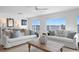 Bright living room with waterfront view and comfortable seating arrangements, perfect for relaxation and entertainment at 7060 S Shore S Dr, South Pasadena, FL 33707
