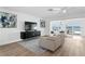 Open living room featuring tile floors, modern decor and waterfront views at 7060 S Shore S Dr, South Pasadena, FL 33707