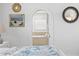 Bright bedroom with ensuite bathroom access, decorated with art and mirrors on the walls at 7060 S Shore S Dr, South Pasadena, FL 33707