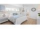 Cozy bedroom features hardwood flooring, a ceiling fan, and an ensuite bathroom at 7060 S Shore S Dr, South Pasadena, FL 33707