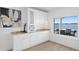 Stylish wet bar with custom cabinetry, granite countertops, wine storage, and views of the waterfront at 7060 S Shore S Dr, South Pasadena, FL 33707