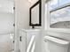 Clean bathroom with white vanity, black hardware, window, and toilet at 7240 Sutton Ln, Sarasota, FL 34240