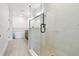 Modern bathroom featuring a glass-enclosed shower, soaking tub, and sleek fixtures at 7240 Sutton Ln, Sarasota, FL 34240
