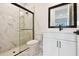 Bathroom with marble shower, white vanity and modern black fixtures at 7240 Sutton Ln, Sarasota, FL 34240