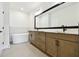 Elegant bathroom with double vanity, soaking tub, and stylish fixtures for a spa-like experience at 7240 Sutton Ln, Sarasota, FL 34240
