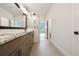 Spacious bathroom featuring double vanity, large mirror, and glass enclosed shower at 7240 Sutton Ln, Sarasota, FL 34240