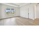 Bright and airy bedroom featuring two windows and modern neutral flooring at 7240 Sutton Ln, Sarasota, FL 34240
