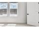 Bright bedroom with two windows, neutral carpet, and white trim at 7240 Sutton Ln, Sarasota, FL 34240