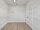Spacious walk-in closet with metal shelving and wood-look flooring at 7240 Sutton Ln, Sarasota, FL 34240