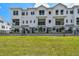 Beautiful exterior of a modern white townhome with a well-maintained green lawn at 7240 Sutton Ln, Sarasota, FL 34240