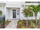 Charming front entrance with a dark front door, stone walkway, and professionally landscaped yard at 7240 Sutton Ln, Sarasota, FL 34240