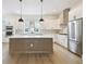 Spacious kitchen with stainless steel appliances, a large island, and white cabinetry at 7240 Sutton Ln, Sarasota, FL 34240