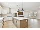 Bright open kitchen featuring white cabinets, stainless steel appliances, and a large island at 7240 Sutton Ln, Sarasota, FL 34240