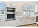 Well-equipped kitchen featuring stainless steel appliances and bright white cabinetry providing ample storage at 7240 Sutton Ln, Sarasota, FL 34240