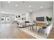 Bright living room featuring a comfortable sofa, modern chairs, and large windows for natural light at 7240 Sutton Ln, Sarasota, FL 34240