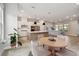 Open-concept living space with modern kitchen, dining area, and light gray sofa, perfect for entertaining at 7240 Sutton Ln, Sarasota, FL 34240
