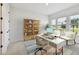 Bright office space featuring a modern desk, stylish bookcase, and comfortable seating with natural light streaming through the windows at 7240 Sutton Ln, Sarasota, FL 34240