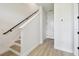 Bright staircase with light wood floors and white walls, leading to the upper level at 7240 Sutton Ln, Sarasota, FL 34240