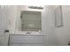 Bathroom with white cabinets, a large mirror, and modern lighting fixtures at 7927 Kosi Palm Pl # 201, Tampa, FL 33615