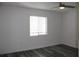 Well-lit bedroom features a neutral color scheme, window, and gray flooring at 7927 Kosi Palm Pl # 201, Tampa, FL 33615