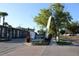 Entrance view of Palmera Pointe with a community sign and 'Move In Specials' flag at 7927 Kosi Palm Pl # 201, Tampa, FL 33615